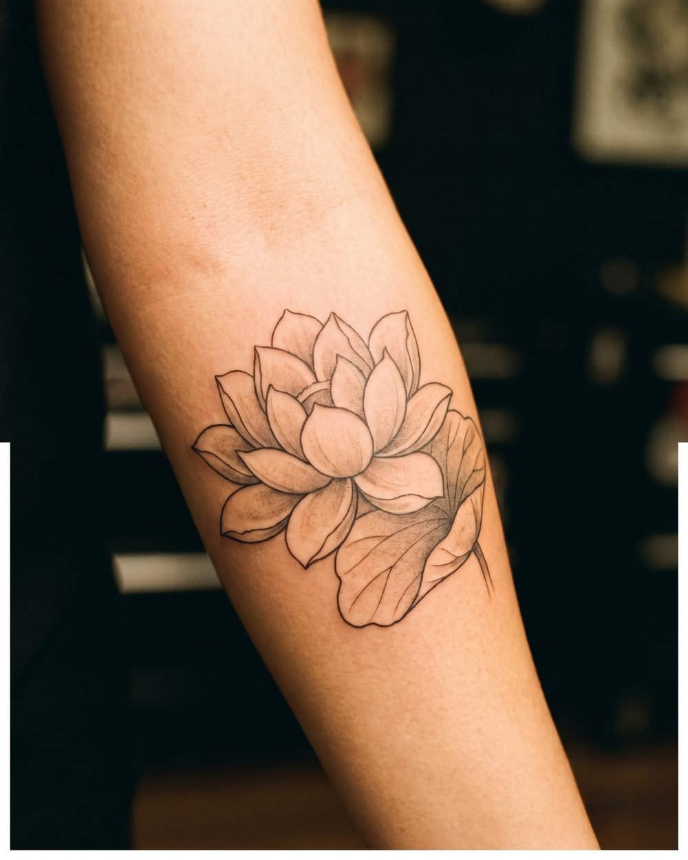 Japanese influenced lotus flower tattoo with fine linework and light shading