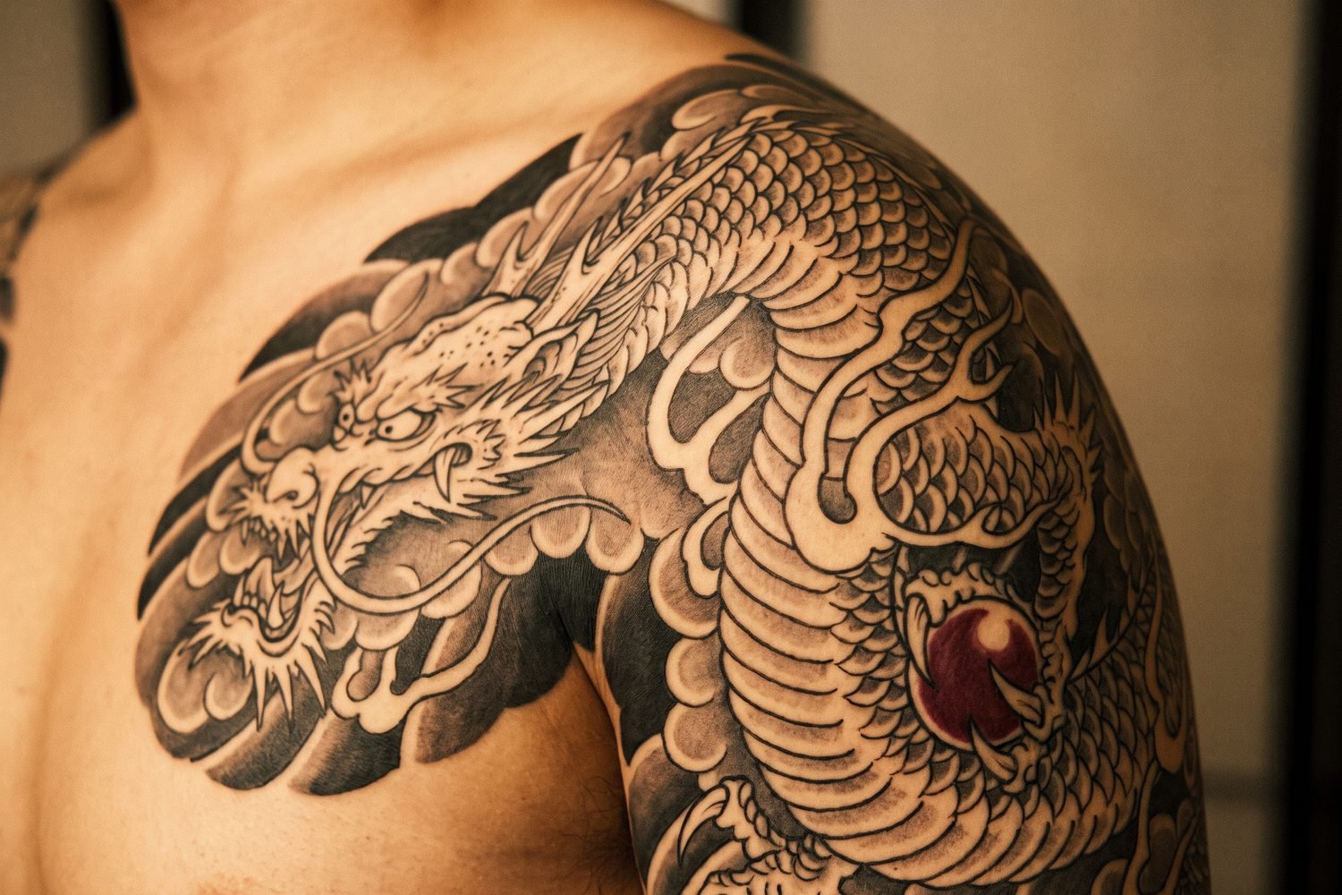 Irezumi style Japanese dragon tattoo coiling through clouds on a shoulder